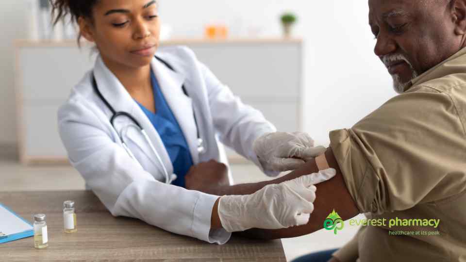Woman in pharmacy adminstrating vaccine
