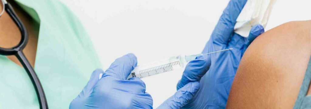 Administering vaccine for yellow fever in the upper arm