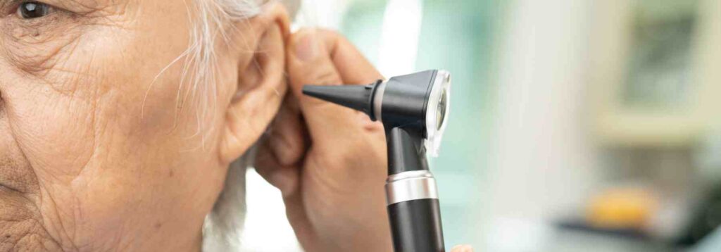 Older patient getting an ear check