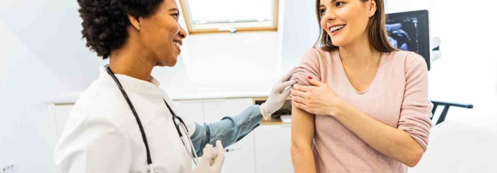 Woman happy to get a travel vaccine in Wales