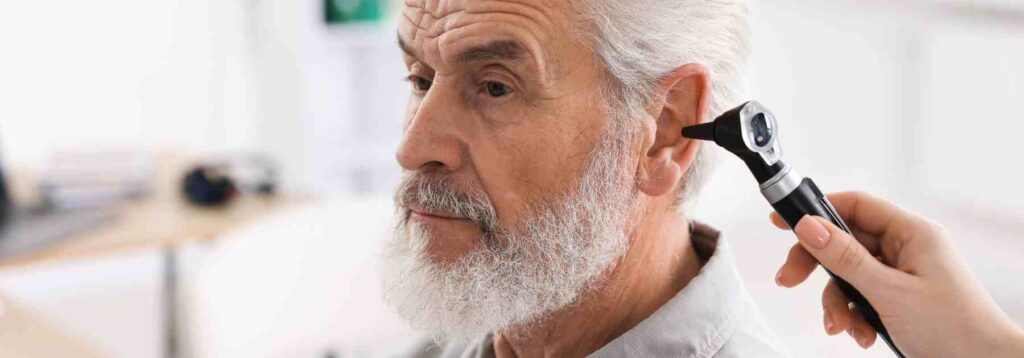 Older man getting a professional ear check