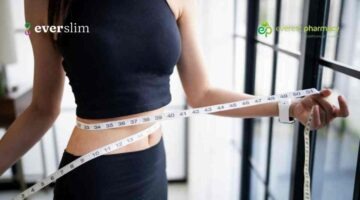 Woman measuring weight loss with tape