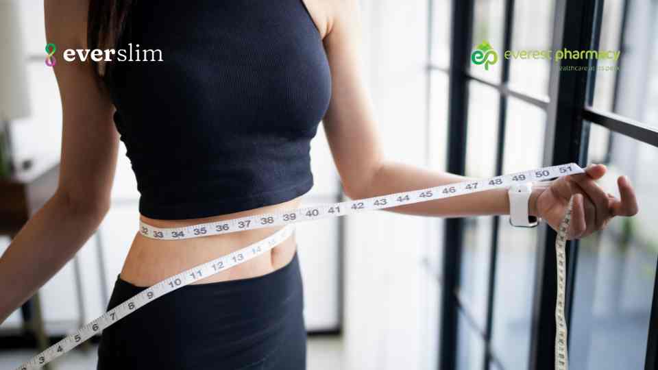 Woman measuring weight loss with tape