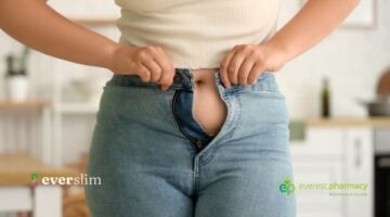 Woman doing up jeans that are too tight