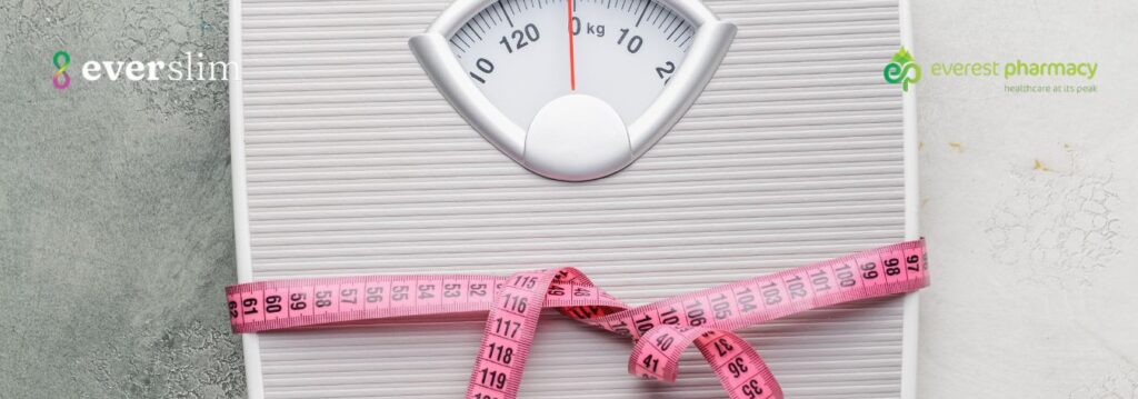 Weighing scales wrapped in a measuring tape represnting weight loss